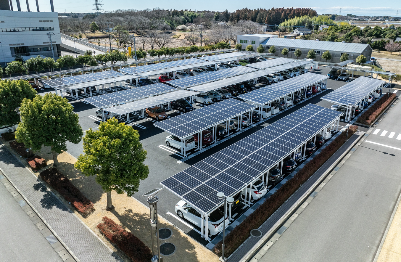 olar carport installation with solar panels providing clean energy and shade for vehicles in a parking lot.